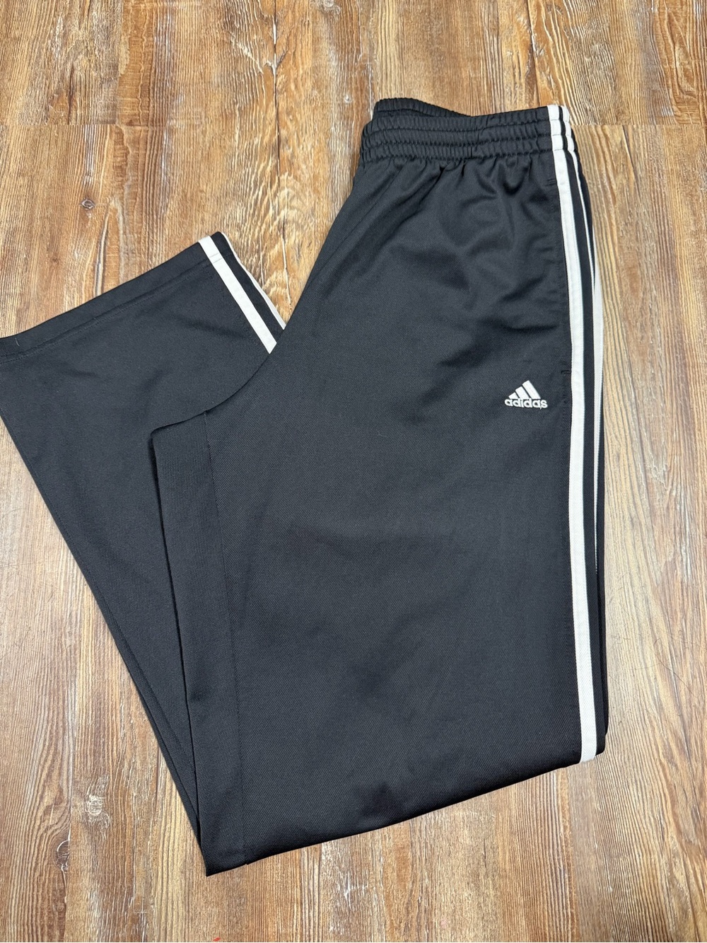 Y2K Adidas black track pants with white stripes, size medium